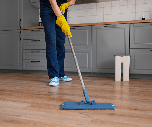 front view woman cleaning home
